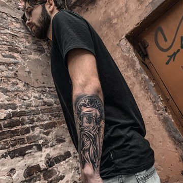 A detailed shot of a blue/green dragon tattoo in Japanese style on the  forearm, elbow and bicep of a white male isolated on a black background. -  Stock Image - Everypixel