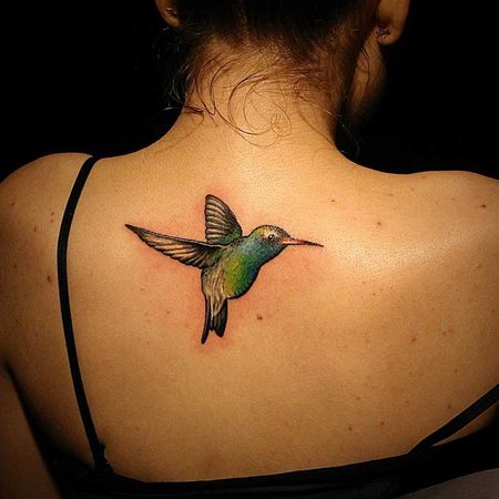Realistic hummingbird tattoo done on the rib.